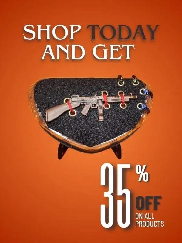 Shop today and get 35% off on all products! Close-up of a decorative motorcycle accessory from FancyBikes.pk, featuring a miniature gun on a black, textured surface with metal eyelets. A promotion for motorcycle accessories Pakistan.