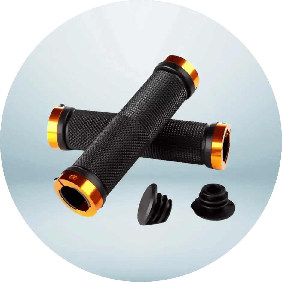 Pair of black bicycle handlebar grips with orange accents, angled on a light blue background. Two black end plugs sit below, ready for installation.