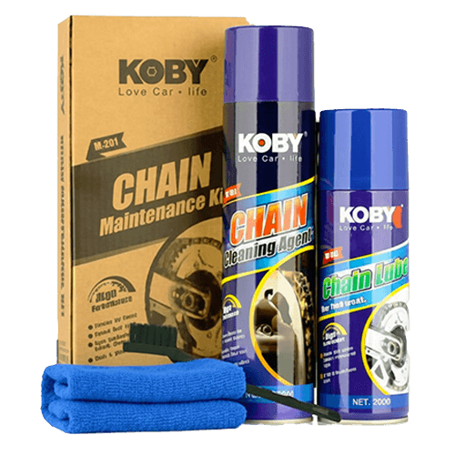 KOBY brand motorcycle chain maintenance kit featuring aerosol cans of chain cleaning agent and lubricant, a scrubbing brush, and microfiber towels.